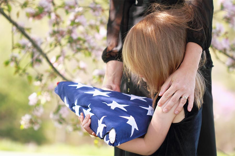 little-girl-holding-folding-american-flag